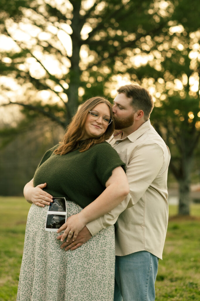 Couples Maternity Pose Holding Ultrasound Photo